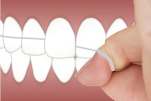 dental-floss in fingers floss wrapped around fingers and teeth
